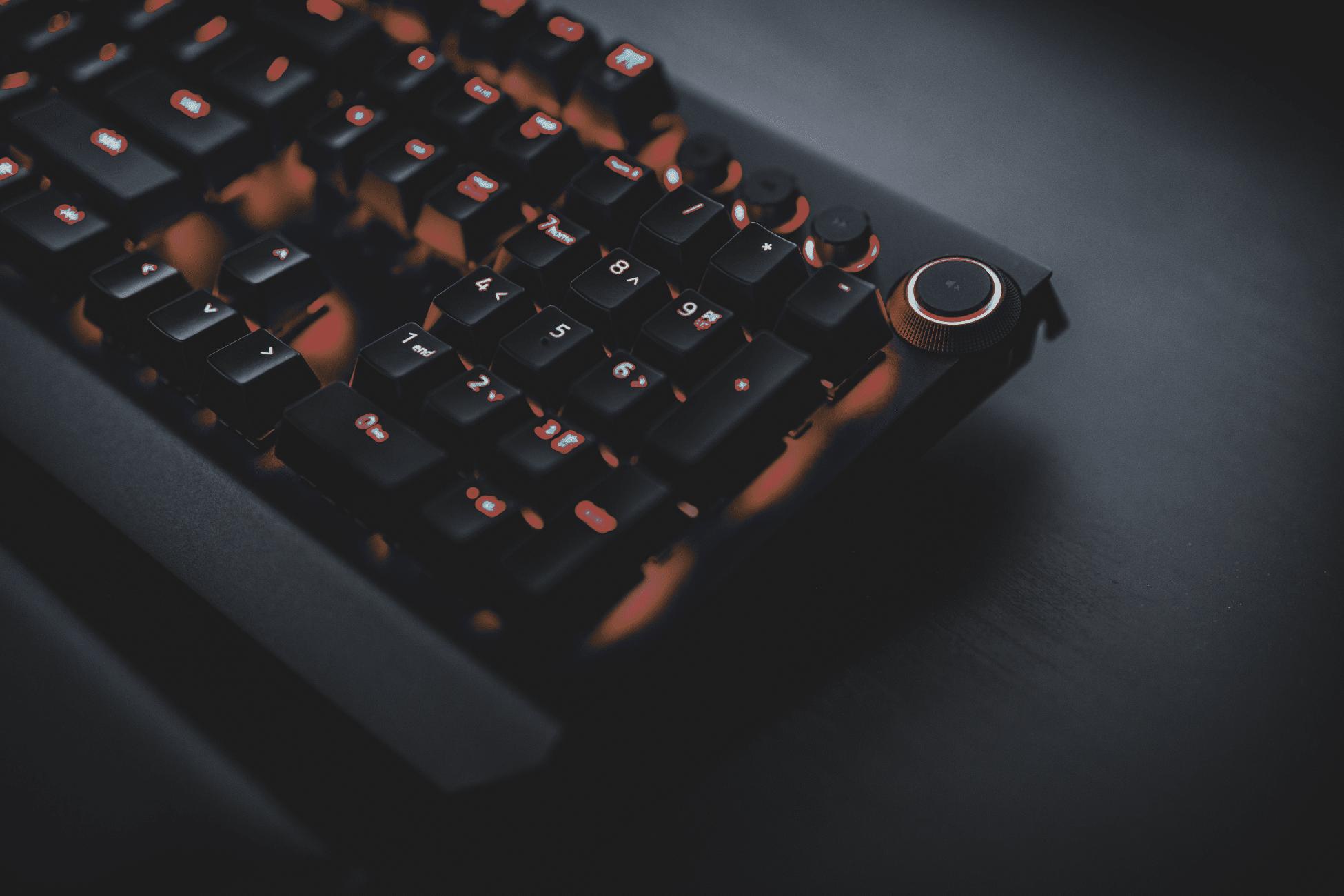 Close-up on the numerical pad of an orange and black keyboard. » admin by request