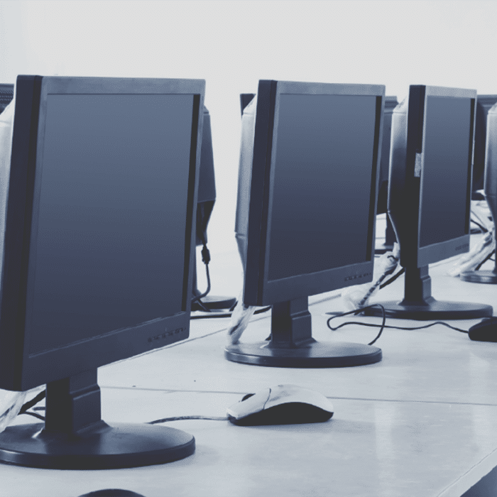 A long desk with a row of monitors on top of it. » admin by request