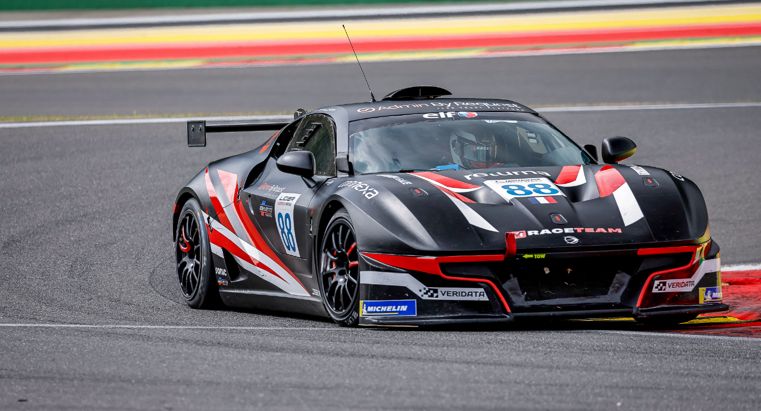 Black gt race car with red and white graphics and number 88 on a racing circuit, moving through a bend. » admin by request