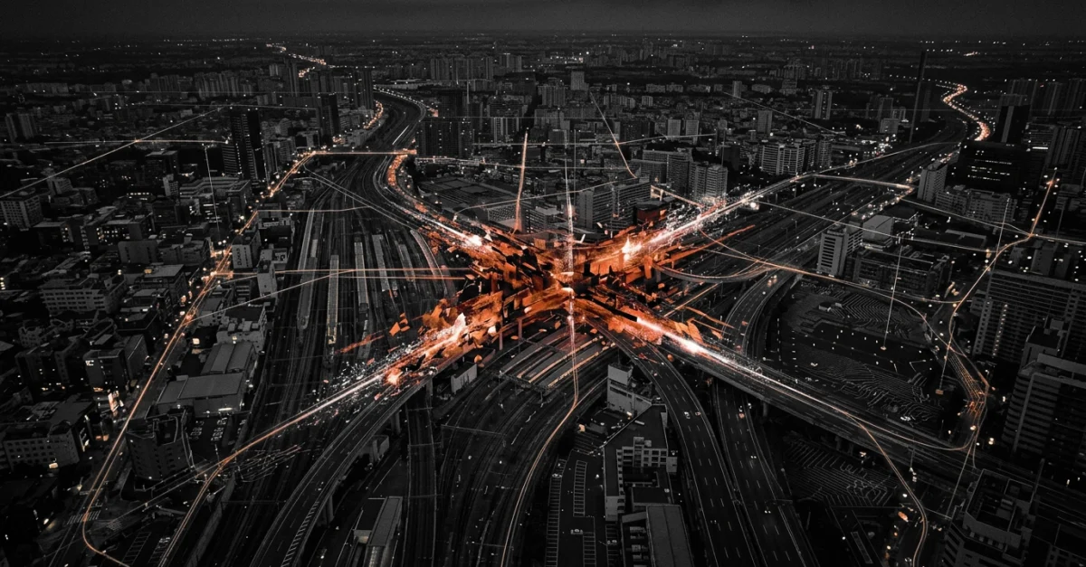 Night aerial of a dense city at dusk with a bright orange highway interchange and glowing data lines converging at the center.