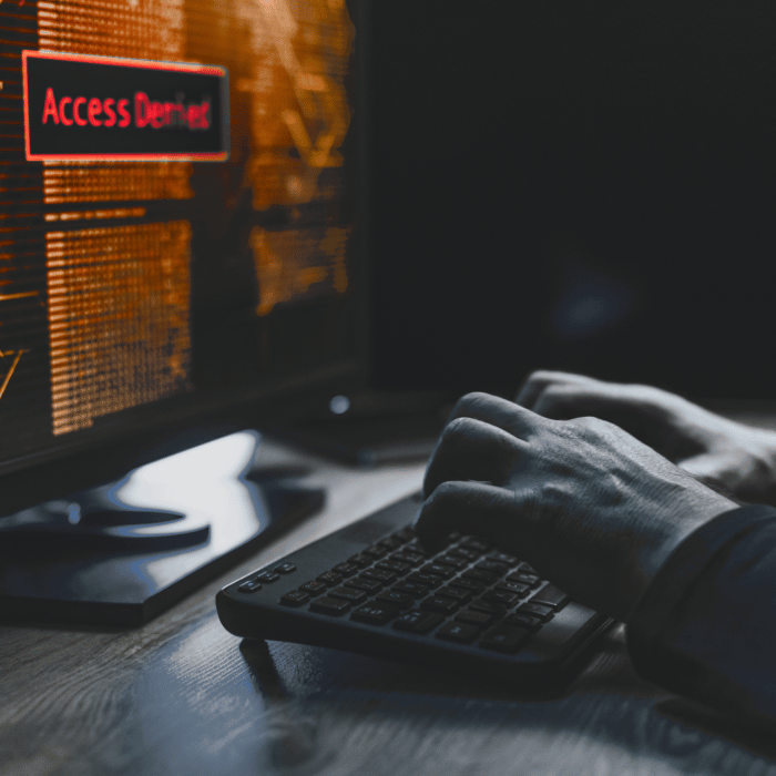 A hacker typing on their computer as their access get denied. » admin by request