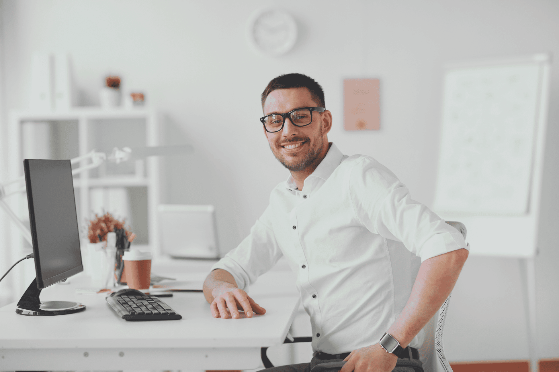 Man wearing glasses, on his computer, smiling at the camera. » admin by request » admin by request