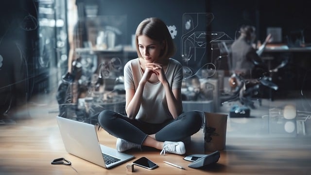 Pam for dummies 5 » admin by request A woman sitting in front of two laptops protected with privileged access management