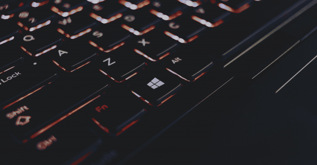 A black Window's keyboard with orange backlighting.